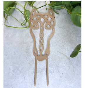 May include: A brown, 3D printed horse head with a Celtic knot design. The horse head is attached to two thin, metal rods.