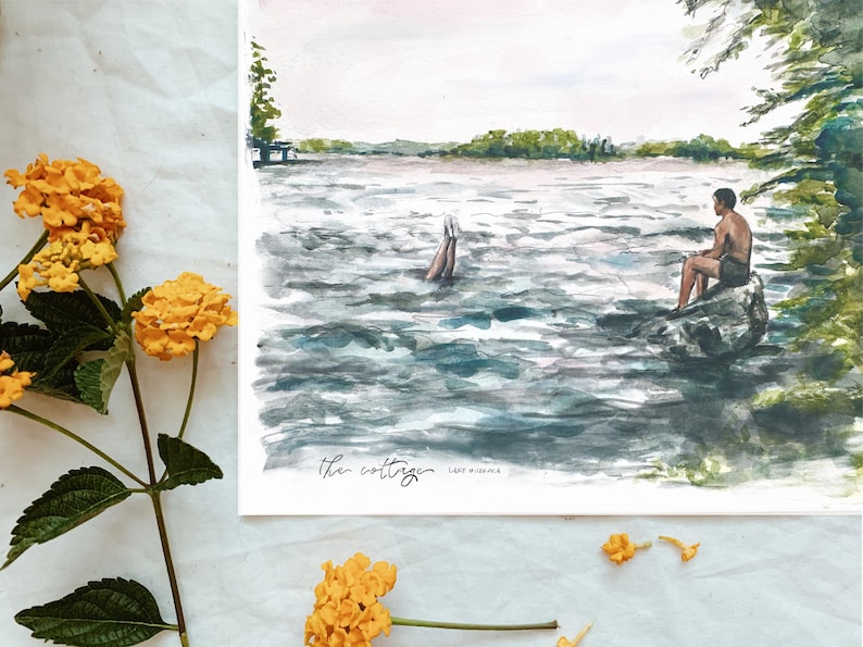 May include: Watercolor painting of a lake scene with a person sitting on a rock and another person diving into the water. The painting is titled "the cottage". Yellow flowers are in the foreground.