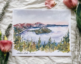 May include: Watercolor painting of Crater Lake National Park, featuring a view of the lake with Wizard Island in the center, surrounded by forested hills. The sky is a soft blue with hints of pink and purple.
