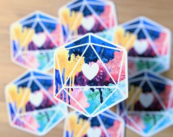 May include: A set of six colourful watercolour stickers featuring a stylised heart inside a geometric shape. The stickers are printed on white paper and have a glossy finish.