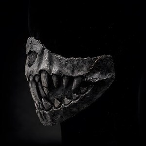 Side view of half mask with fangs, handmade macabre mask highlighting fang profile and lightweight structure