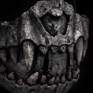 Macro detail of fangs on half mask, handmade dark art showing sculpted teeth and realistic surface texture