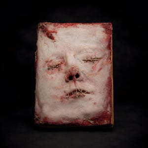 Human skin face book handmade dark art, macabre sculptural book featuring realistic human face relief on skin-textured cover