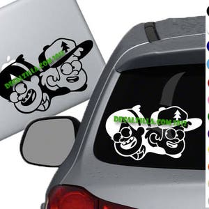 May include: Black and white decal sticker featuring two cartoon characters from the show Gravity Falls. The characters are Dipper Pines and Mabel Pines. The sticker is on a gray car.