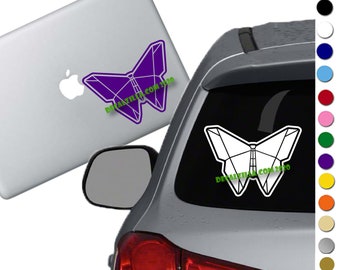 May include: A white car with a purple butterfly sticker on the back window. The sticker has the text "decalzilla.com 2010" on it.