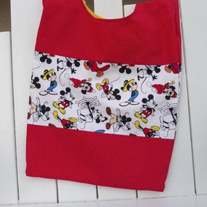 May include: Red and white fabric with a Mickey Mouse print. The fabric has a red polka dot pattern and a white stripe with Mickey Mouse characters.