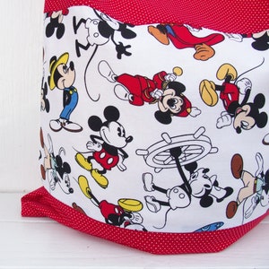 May include: Red and white fabric tote bag with a polka dot pattern. The bag features a repeating pattern of Mickey Mouse characters in various poses.