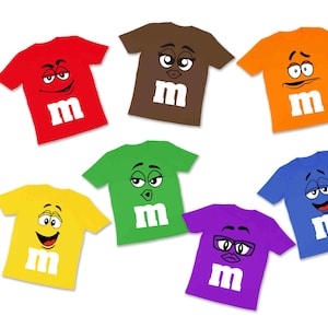 May include: Seven colourful t-shirts featuring different M&M's characters. Each shirt is a different colour and has a unique character with a distinct expression.