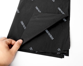 May include: Black tissue paper with the repeated text "Todd Patrick" printed in white.