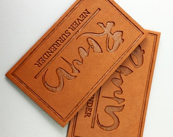 May include: Two brown leather patches with the text "Never Surrender" and the word "Always" in a stylized font.