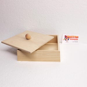 May include: A natural wood box with a hinged lid and a wooden knob. The box is empty and ready to be filled with treasures.