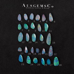May include: A selection of 28 opals in diverse shapes and sizes, presented on a black background. The opals showcase a spectrum of colours, including blues, greens, and reds, with shimmering patterns. The image includes the text "AUSGEMSCo Handmade Jewelry & Design".