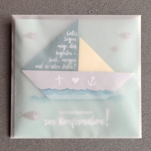May include: A light blue and white card with a paper sailboat design. The card has the text "Gottes Segen m&ouml;ge dich begleiten - heute, morgen und in allen Zeiten!" and "zur Konfirmation!"