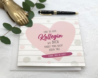 May include: A pink and white card with a pink heart in the center. The card says "EINE SO GUTE Kollegin WIE DICH FINDET MAN NICHT JEDEN TAG! SCHADE, DASS DU GEHSTI".