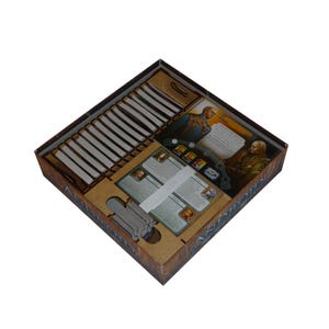 May include: A brown cardboard box with a custom insert for organising board game components. The insert has slots for cards, tokens, and other game pieces. The box is open and the insert is visible.