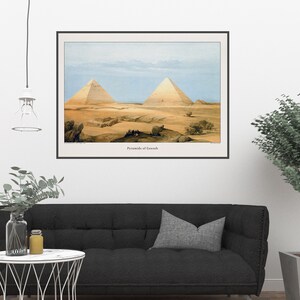 May include: A vintage illustration of the Pyramids of Giza, showing two large pyramids in the desert landscape. The image is in a black frame and has the text "Pyramids of Gizeh" at the bottom.