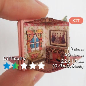 May include: A miniature papercraft kit of a room with a fireplace, a window with curtains, and a picture on the wall. The kit includes 17 pieces and takes approximately 40 minutes to assemble. The finished model is 2.2 x 1.5 inches (0.9 x 0.6 inches). The difficulty level is rated with four out of five stars.