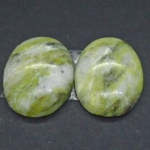 May include: Two oval-shaped green and white stones with a marbled pattern.