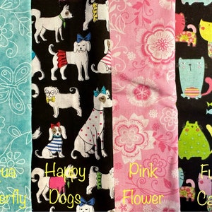 May include: Four fabric swatches with different patterns. The first is aqua blue with white butterfly and flower designs. The second is black with white dogs wearing clothes and accessories. The third is pink with white flowers. The fourth is black with colorful cats and fish.