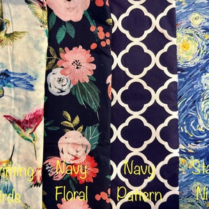 May include: Four fabric swatches with different patterns. The first swatch features a white background with colorful hummingbirds. The second swatch has a navy blue background with a pink and green floral pattern. The third swatch has a navy blue background with a white geometric pattern. The fourth swatch has a blue background with a swirling, yellow, and white pattern reminiscent of Van Gogh's Starry Night.