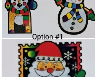 May include: Three Christmas-themed cutouts: a reindeer with colorful antlers and a scarf, a snowman with a hat and scarf, and Santa Claus in a postage stamp design. The text "Option #1" is visible.