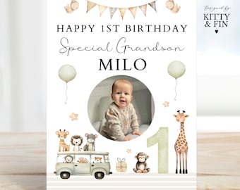 May include: A birthday card with a safari theme. It features a photo of a baby boy, a green number one, and a variety of animals including a giraffe, a monkey, and a lion. The card says "Happy 1st Birthday Special Grandson Milo".