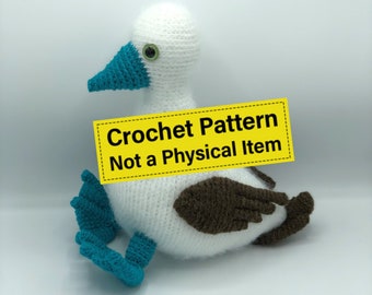 May include: A crochet pattern for a blue-footed booby bird. The pattern is not a physical item, but a digital download. The image shows a crocheted blue-footed booby bird with white and brown yarn, and blue feet.