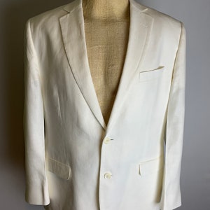 May include: A white linen blazer with a two-button closure and two front pockets.