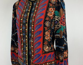 May include: A black velvet jacket with a colorful floral print. The jacket has a gold trim and button closure.
