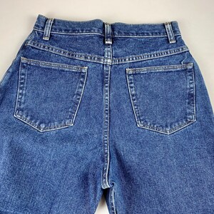 May include: A pair of blue denim jeans with two back pockets.