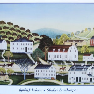 May include: A folk art print titled "Shaker Landscape" by Kathy Jakobsen. The artwork depicts a rural scene with white buildings, trees, and rolling hills. A horse-drawn cart and a person on horseback are also visible. The color palette includes shades of green, blue, and brown.