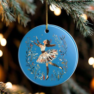 May include: A white ceramic mug with a black handle and the text "But first, coffee" in a black, handwritten-style font. The mug is on a white surface.