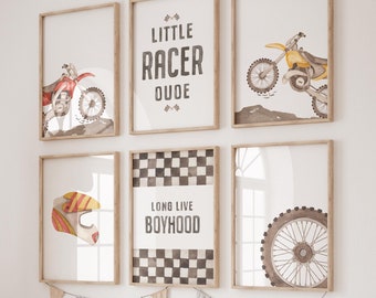 May include: Six framed prints with a motocross theme. The prints feature a checkered pattern, a motorcycle helmet, a motorcycle wheel, and a motorcycle. The text on the prints reads "Little Racer Dude" and "Long Live Boyhood".