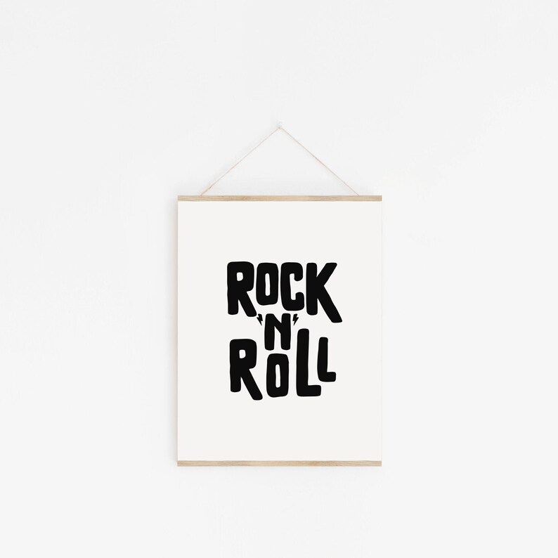May include: A white framed print with black text that reads "Rock 'n' Roll".