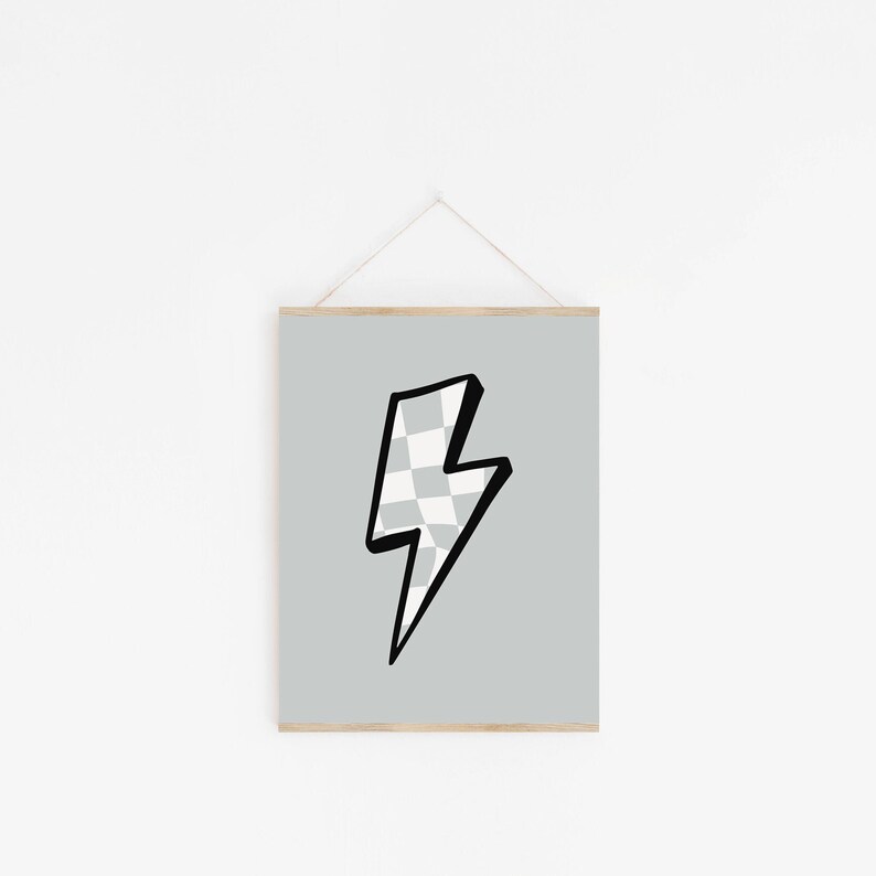 May include: A framed print with a gray background and a black and white checkered lightning bolt graphic.