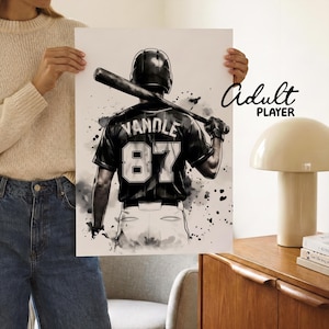 May include: A black and white art print featuring a baseball player from behind, wearing a helmet and a jersey with the name VANDLE and the number 87. The player holds a baseball bat over their shoulder, set against a splattered ink background.