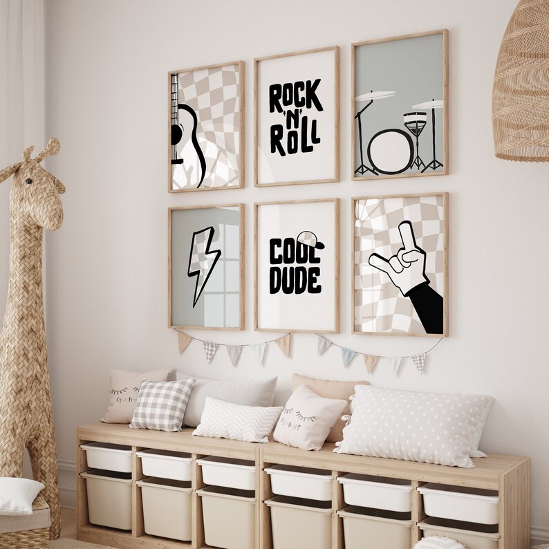May include: Six framed prints with black and white illustrations of musical instruments, a lightning bolt, a hand making the rock and roll sign, and the words "Rock 'n' Roll" and "Cool Dude". The prints are arranged in a grid on a white wall above a wooden bench with pillows.