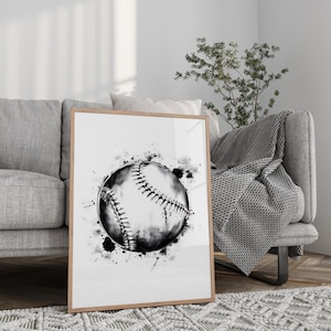 May include: A framed wall art print featuring a black and white watercolor illustration of a baseball. The design showcases a detailed baseball with visible stitching, surrounded by artistic ink splatters and splashes on a clean white background.