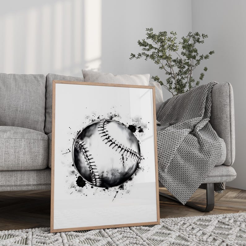 May include: A framed wall art print featuring a black and white watercolor illustration of a baseball. The design showcases a detailed baseball with visible stitching, surrounded by artistic ink splatters and splashes on a clean white background.