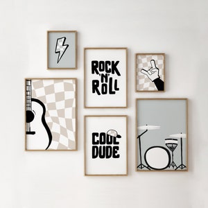 May include: A set of six black and white framed prints with a rock and roll theme. The prints feature a guitar, a drum set, a lightning bolt, a hand making the rock and roll sign, and the words "Rock 'n' Roll" and "Cool Dude".