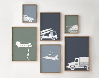 May include: A set of nine framed prints featuring various military vehicles and aircraft in white silhouettes against a blue or green background. The prints include a jeep, a tank, a helicopter, a missile launcher, a fighter jet, and a truck.