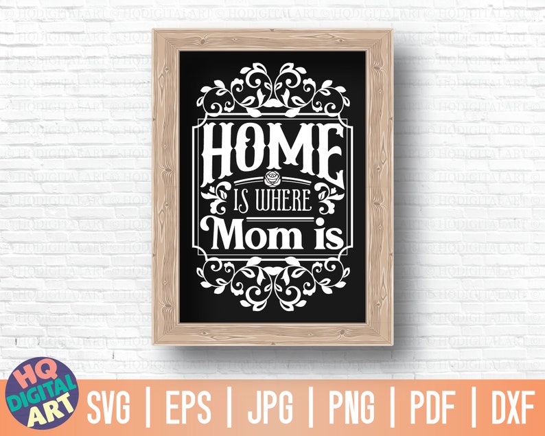 May include: A black and white sign with a wooden frame that reads "Home is where Mom is". The sign has a decorative floral design around the text.