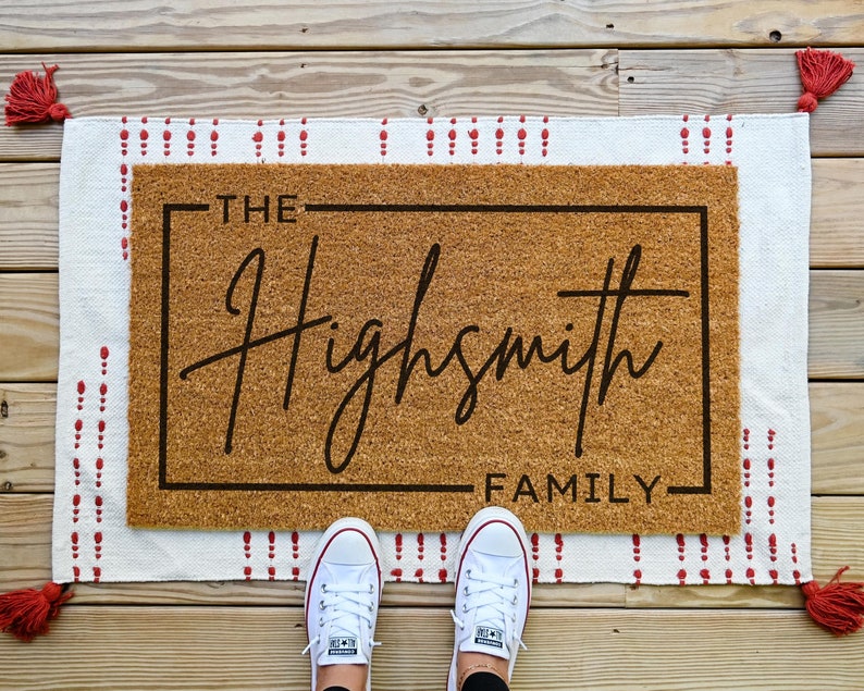 personalized doormat with last name in cursive with a border around the edge. you can customize the doormat with your own last name.