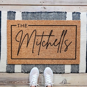 custom welcome doormat that says a last name in cusive.This mat can be personalized.
