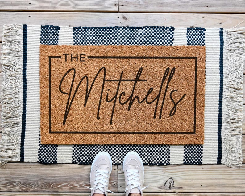 custom welcome doormat that says a last name in cusive.This mat can be personalized.