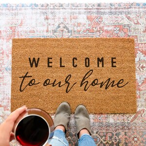 Coir welcome to our home doormat.  Welcome bold and to our home in cursive.