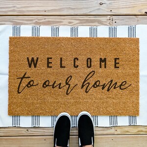 Coir welcome to our home doormat.  Welcome bold and to our home in cursive.