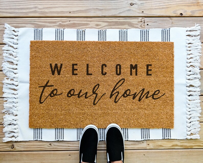 Coir welcome to our home doormat.  Welcome bold and to our home in cursive.