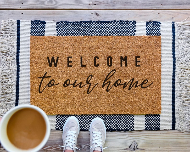 Coir welcome to our home doormat.  Welcome bold and to our home in cursive.