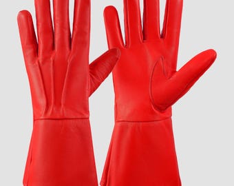May include: A pair of red leather gloves with long cuffs. The gloves are made of a soft, supple leather and have a classic design.